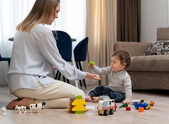 Adult and child playing with toys on a living room floor.