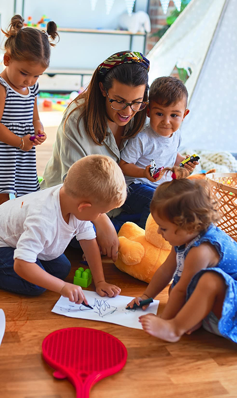 Teacher Engaging Children in Creative Activities at Day Care Porter Ranch