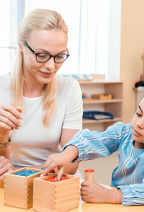 Teacher Assisting Child with Educational Blocks in Day Care Porter Ranch